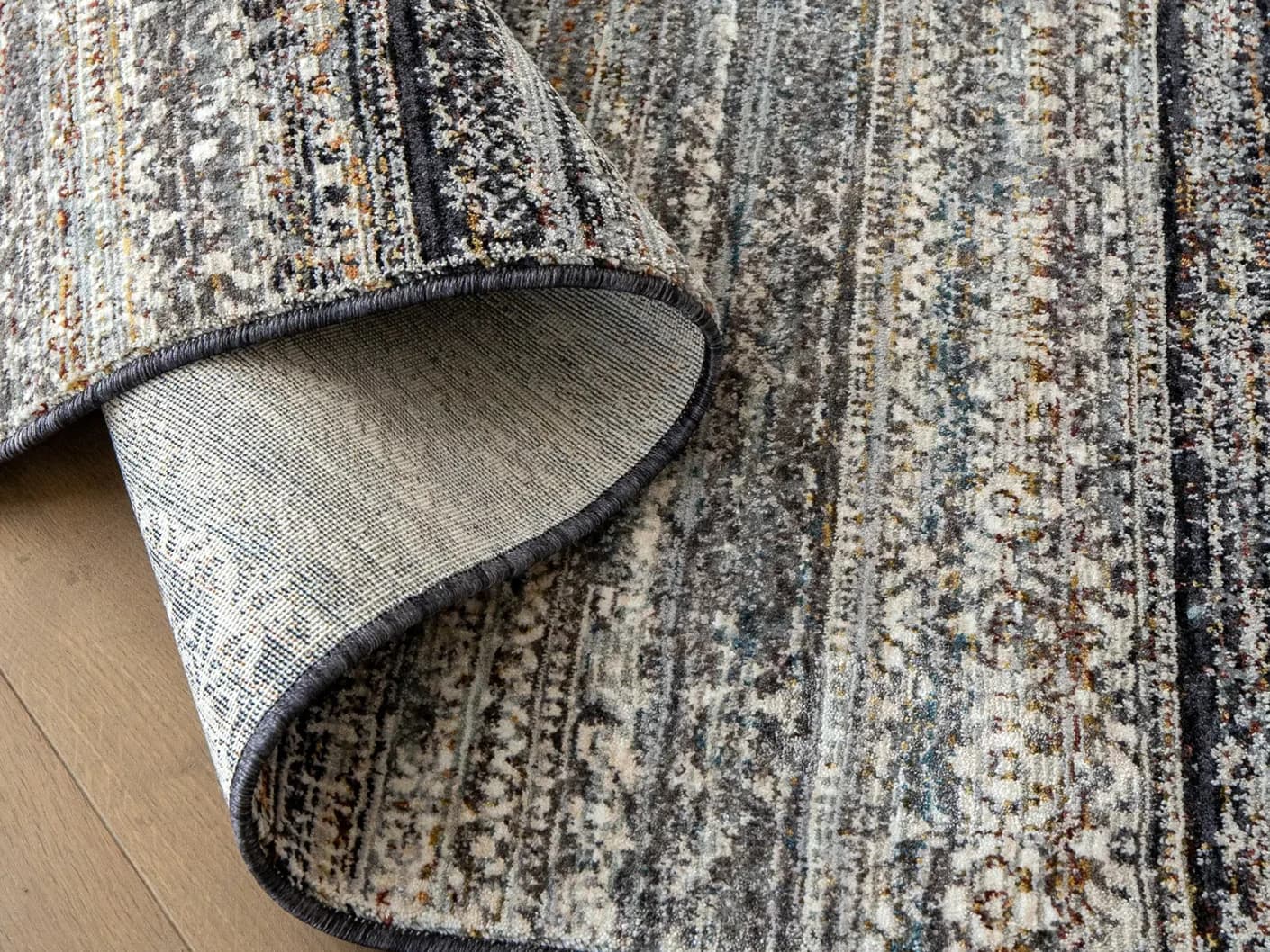 Ethan Ebony carpets in ebony and grey, shown in a product close-up view
