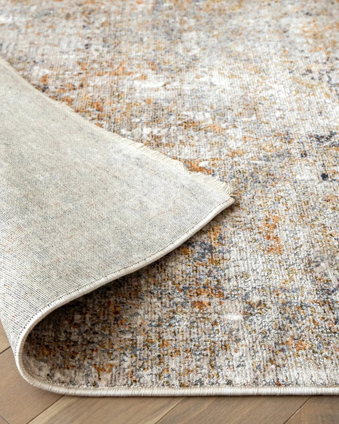 Ethan Goldberg carpet in rust, grey and gold, shown in a product close-up as image 9