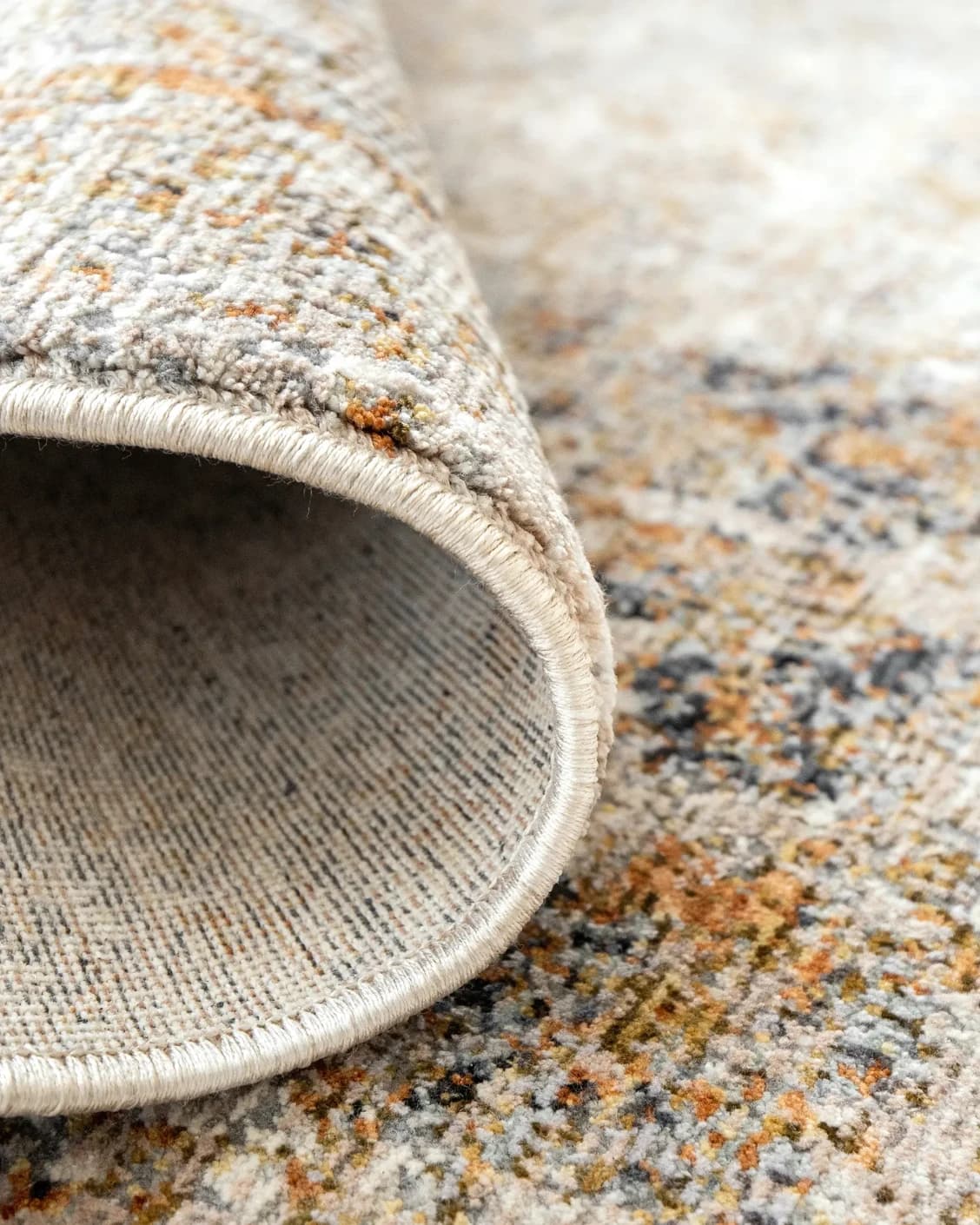 Ethan Goldberg carpet in rust, grey and gold, shown in a product close-up as image 10