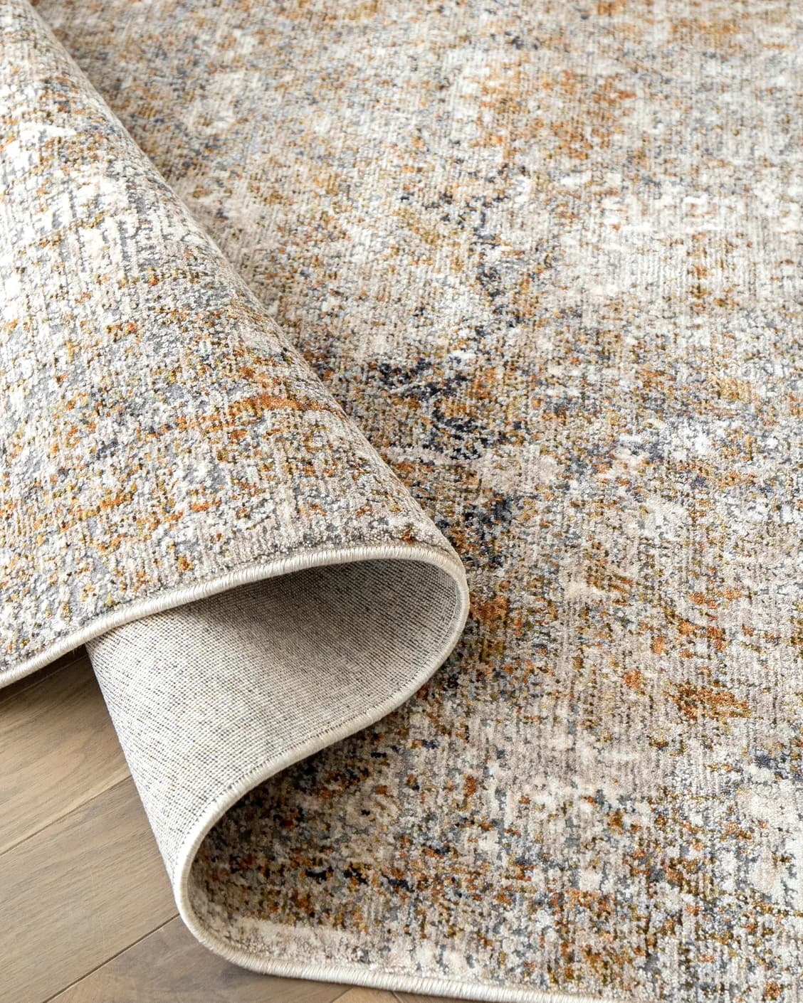 Ethan Goldberg carpet in rust, grey and gold, shown in a product close-up as image 11