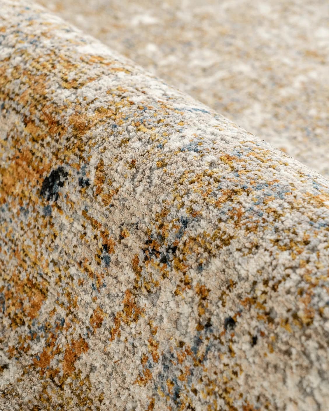 Ethan Goldberg carpet in rust, grey and gold, shown in a product close-up as image 12