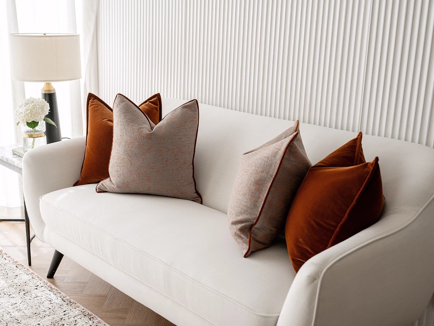 Evander Bundle bundle cushions in rust, shown in a lifestyle front view