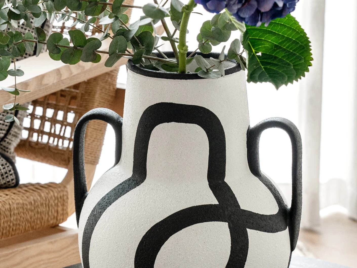 Evelina Arneson vases in black and white, shown in a lifestyle front view