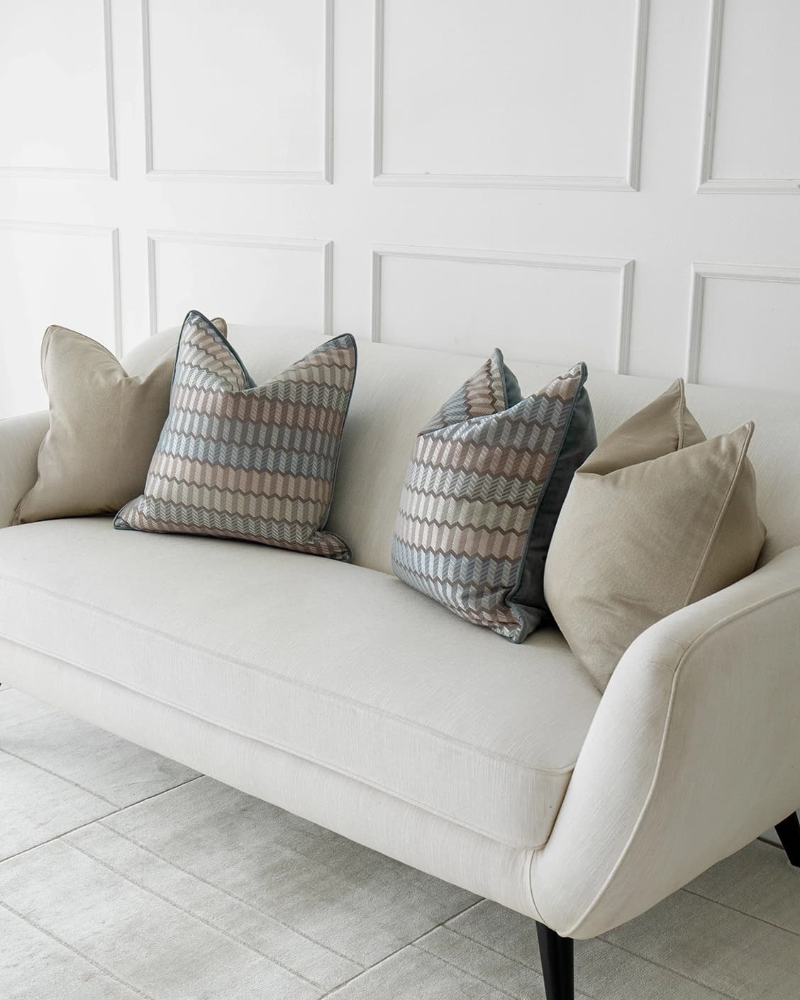 Evie Bundle cushion in silver, blue, gold and beige, shown in a lifestyle right view as image 2