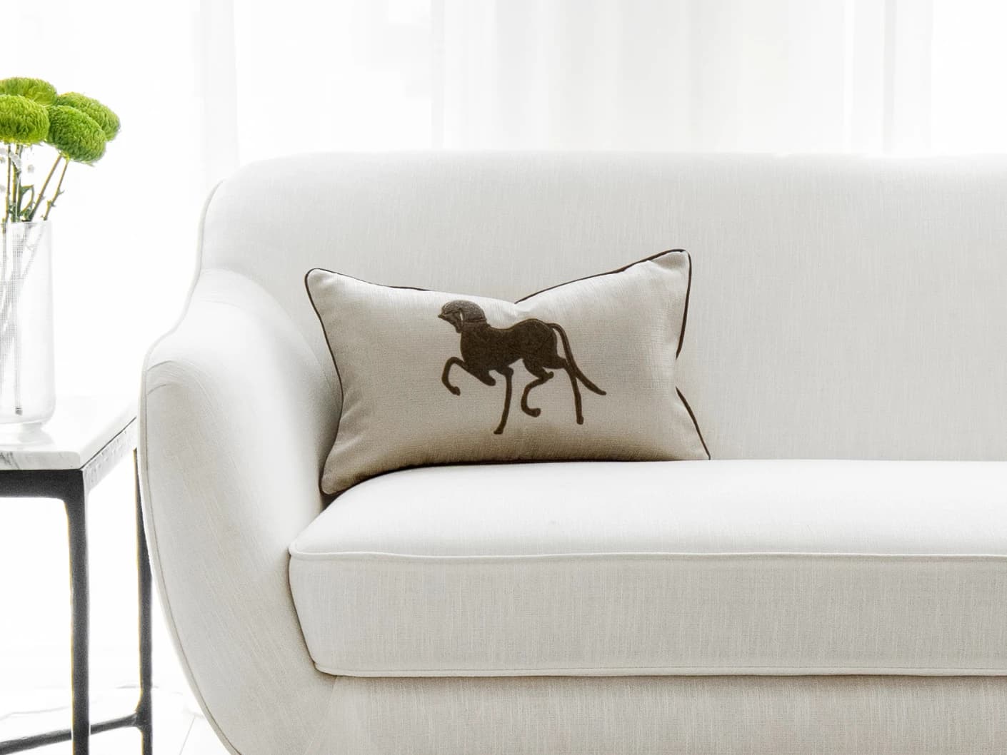 Faaris Laurent single cushions in brown and beige, shown in a lifestyle front view