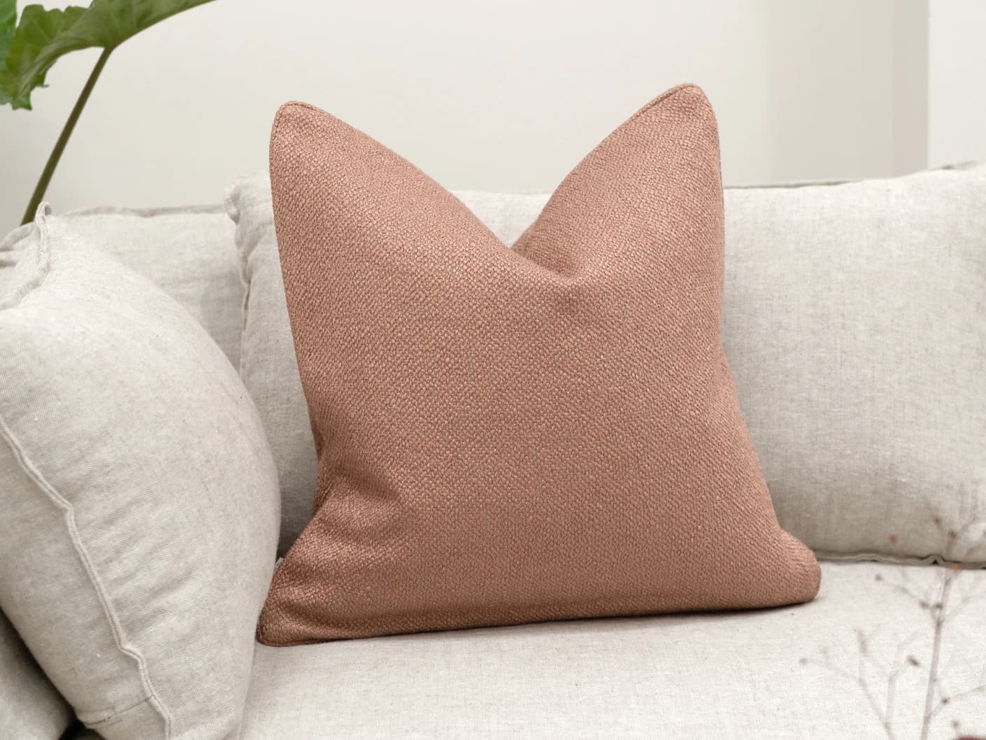 Fae Blush single cushions in pink, shown in a lifestyle front view
