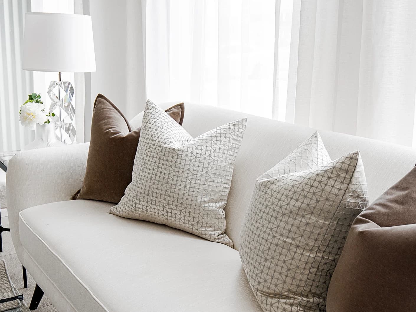 Farah Bundle bundle cushions in brown and silver, shown in a lifestyle front view
