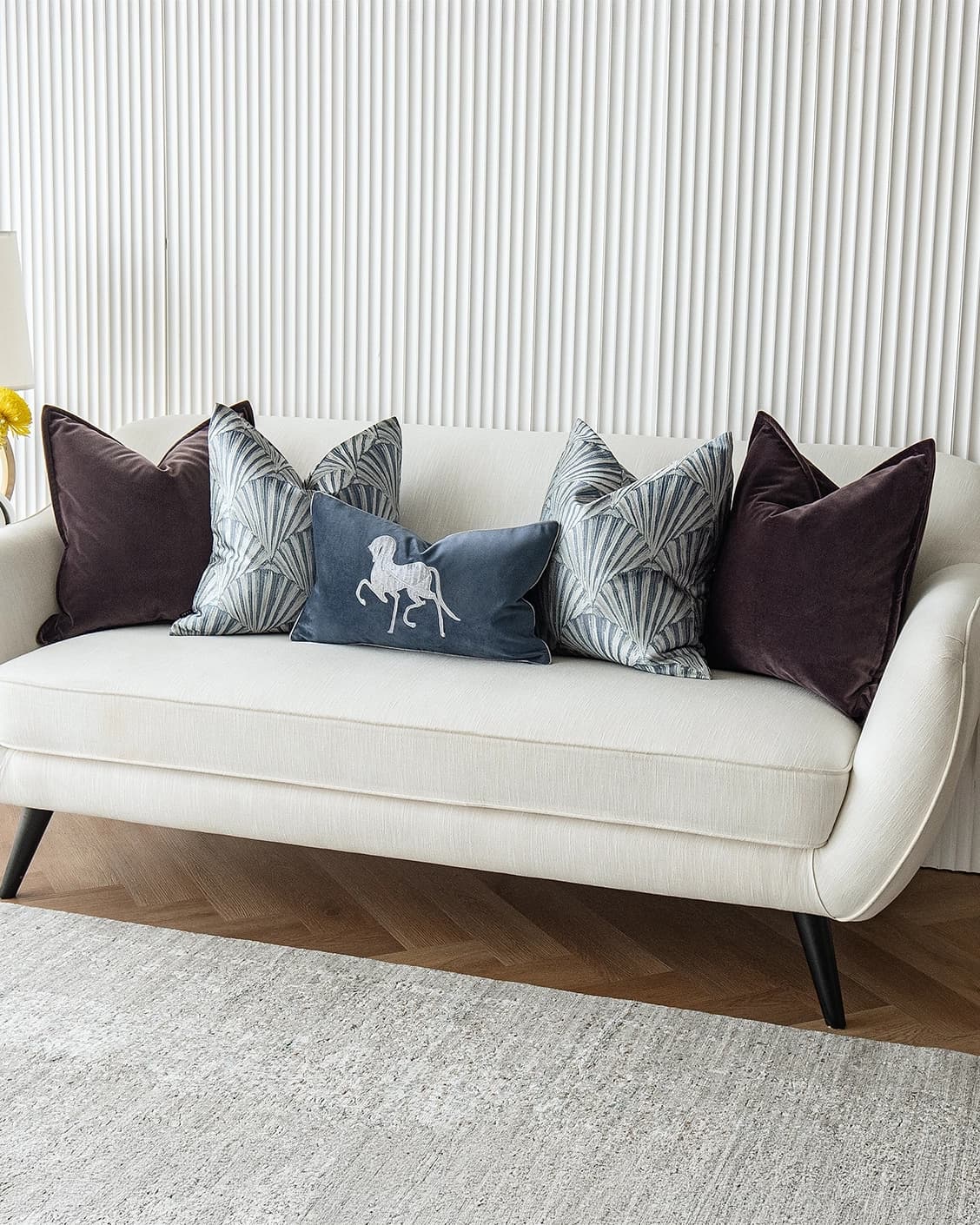 Fiavola Bundle cushion in purple, blue and silver, shown in a lifestyle right view as image 2