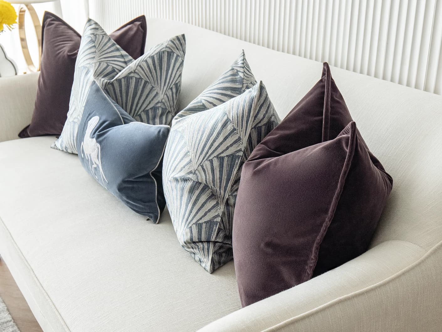 Fiavola Bundle bundle cushions in purple, blue and silver, shown in a lifestyle front view