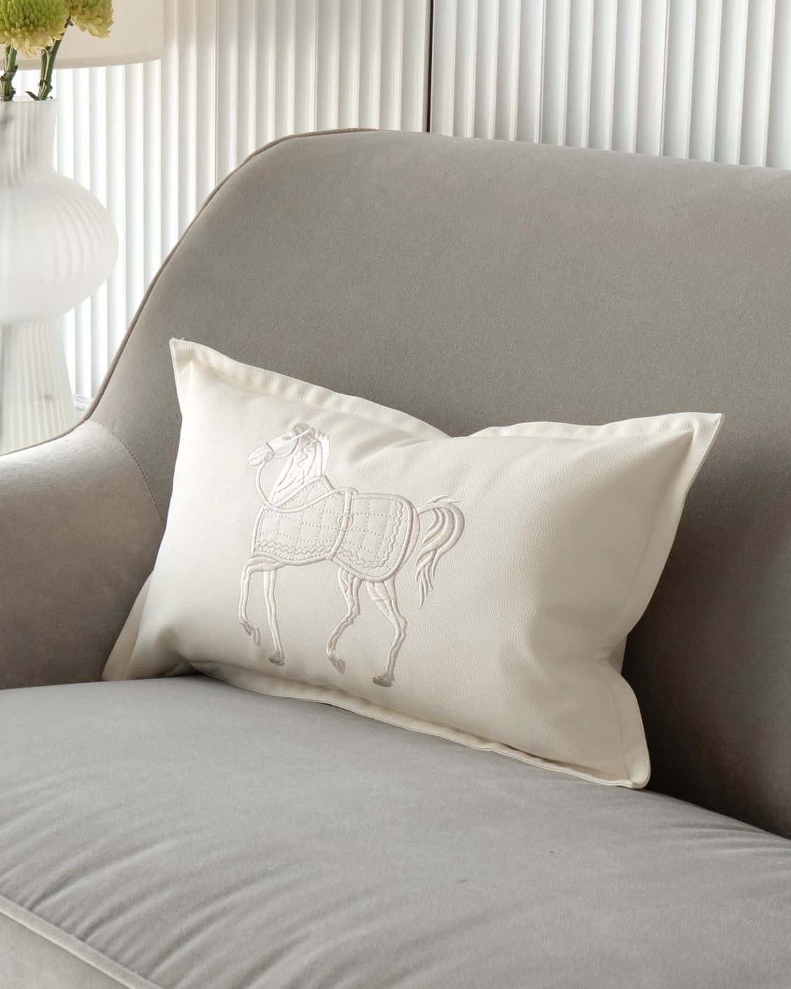 Filip Caravaggio cushion in white, shown in a lifestyle front view as image 2