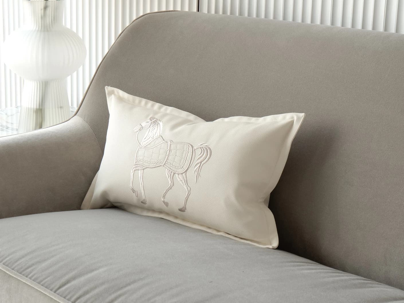 Filip Caravaggio single cushions in white, shown in a lifestyle front view