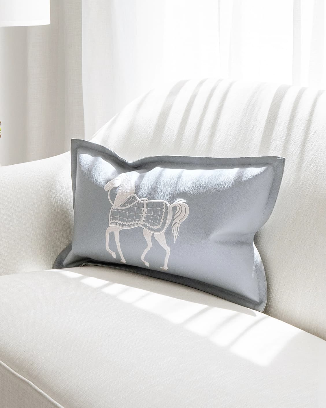 Filip Matisse cushion in blue and white, shown in a lifestyle front view as image 2