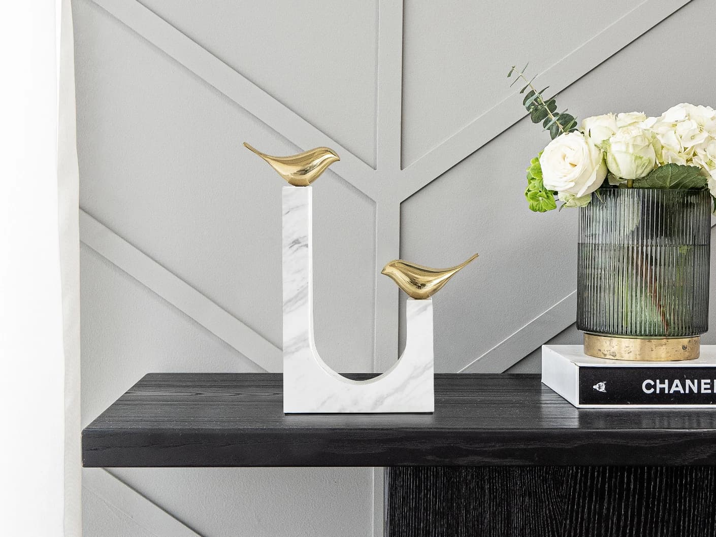 Finch Butterfield statues and sculptures in white and gold, shown in a lifestyle front view
