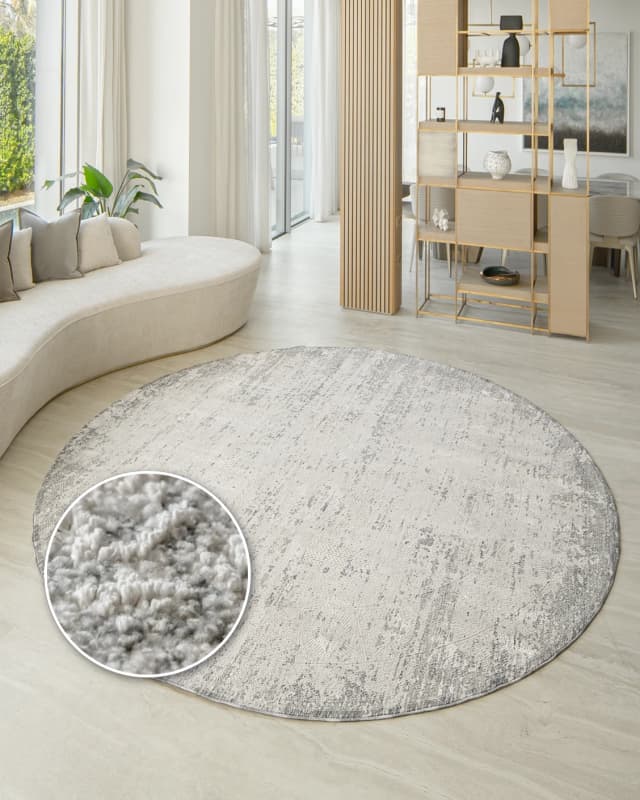 Finley Dune Round carpet in grey, shown in a lifestyle front view