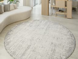 Finley Dune Round carpet in grey, shown in a lifestyle front view