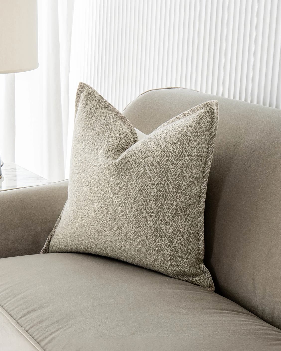 Fleur Bianca cushion in beige, shown in a lifestyle front view as image 2