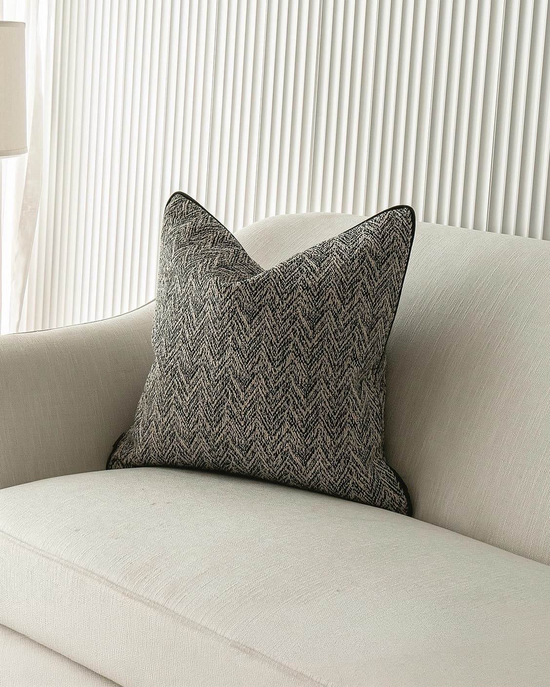 Fleur Steele cushion in black and white, shown in a lifestyle front view as image 2