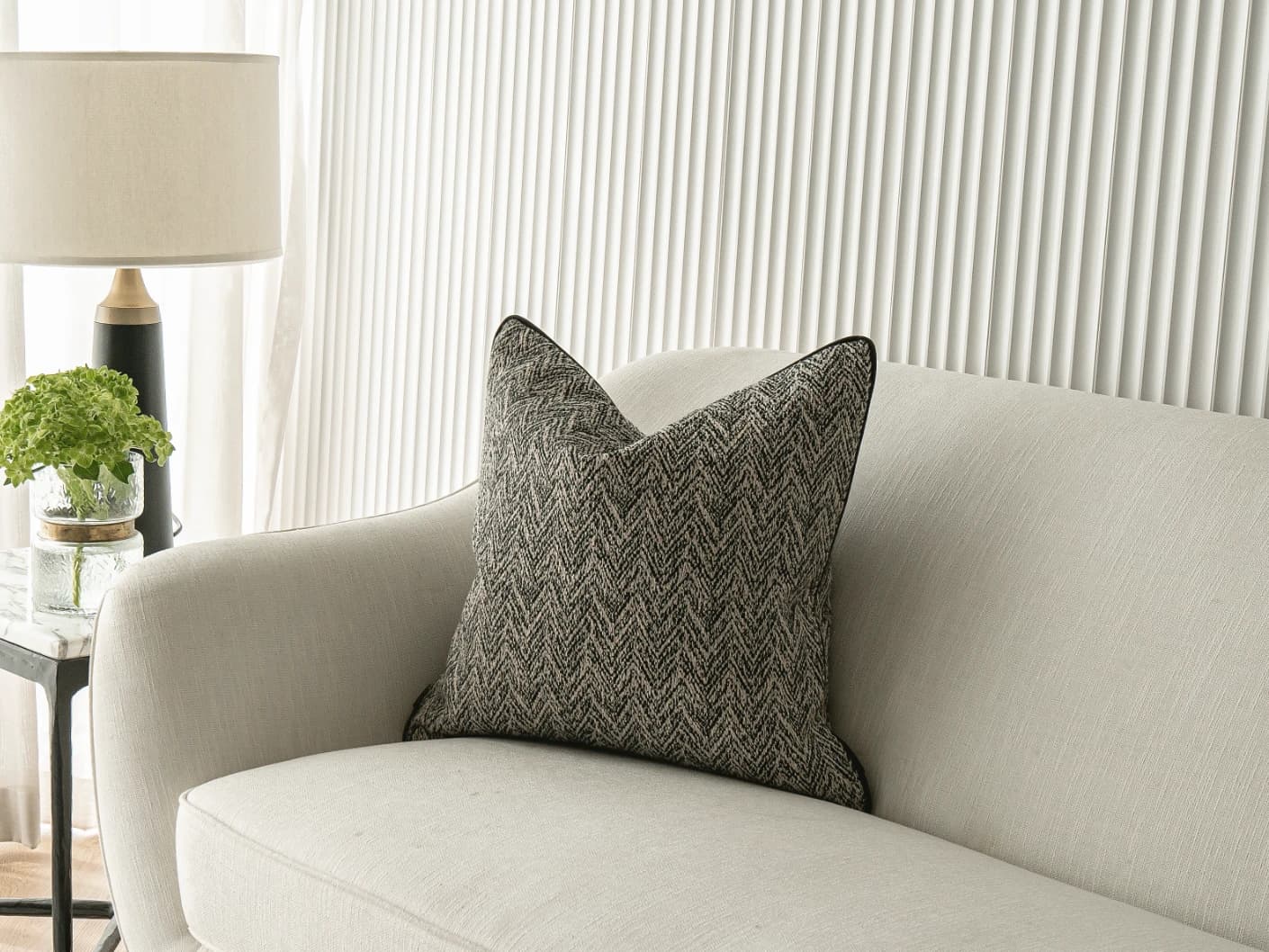 Fleur Steele single cushions in black and white, shown in a lifestyle front view