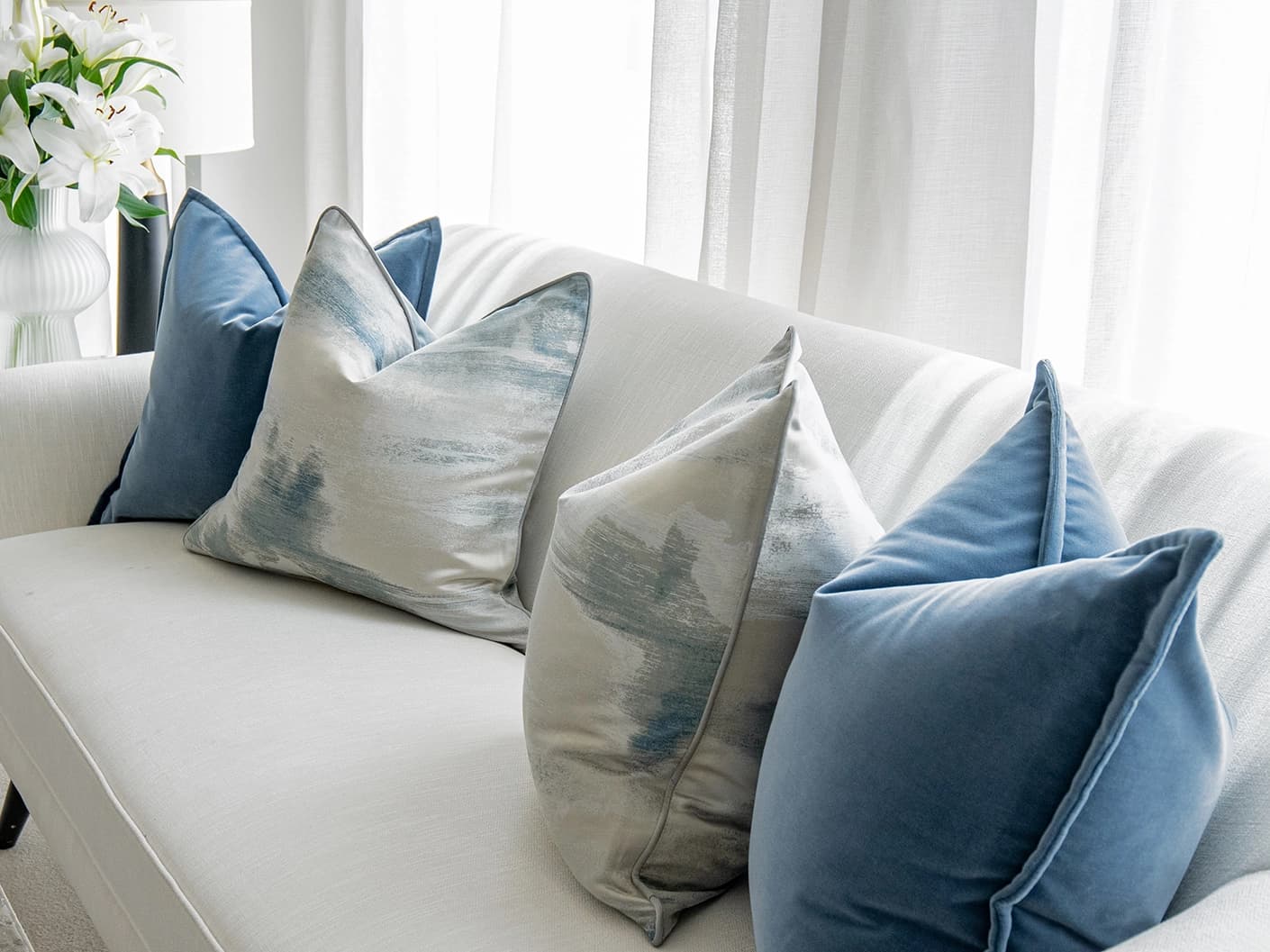 Francine Bundle bundle cushions in blue and silver, shown in a lifestyle front view