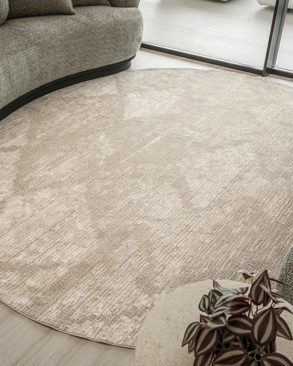 Freida Sandy Round carpet in beige, shown in a lifestyle close-up as image 4