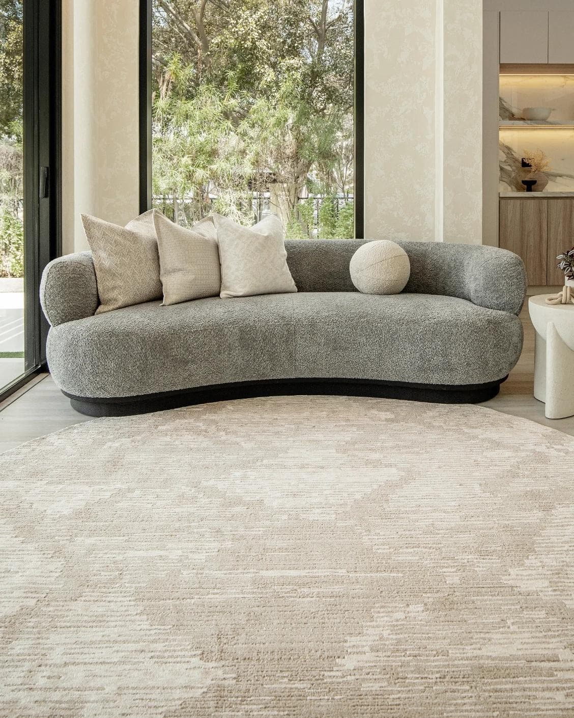 Freida Sandy Round carpet in beige, shown in a lifestyle front view as image 5