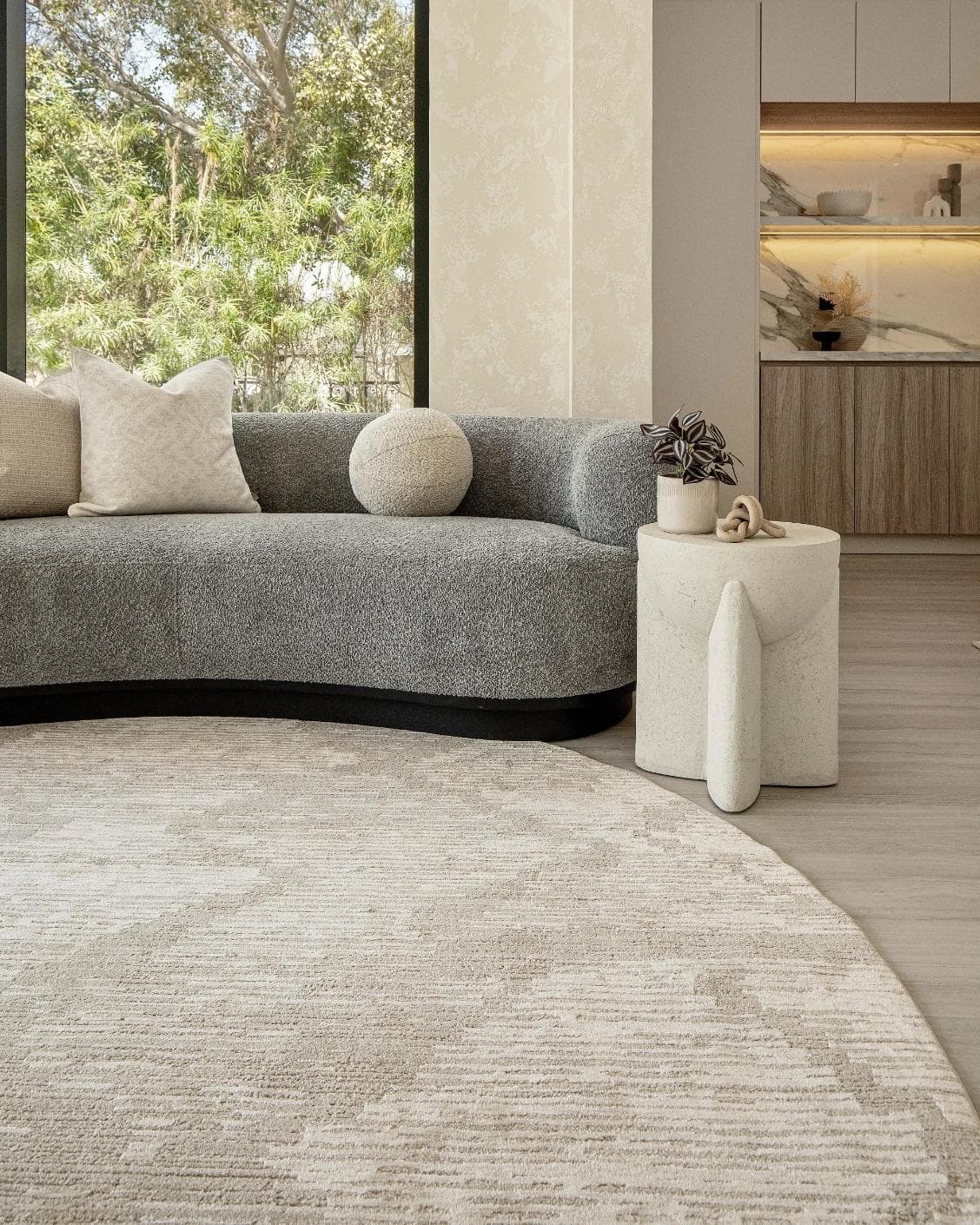 Freida Sandy Round carpet in beige, shown in a lifestyle front view as image 6