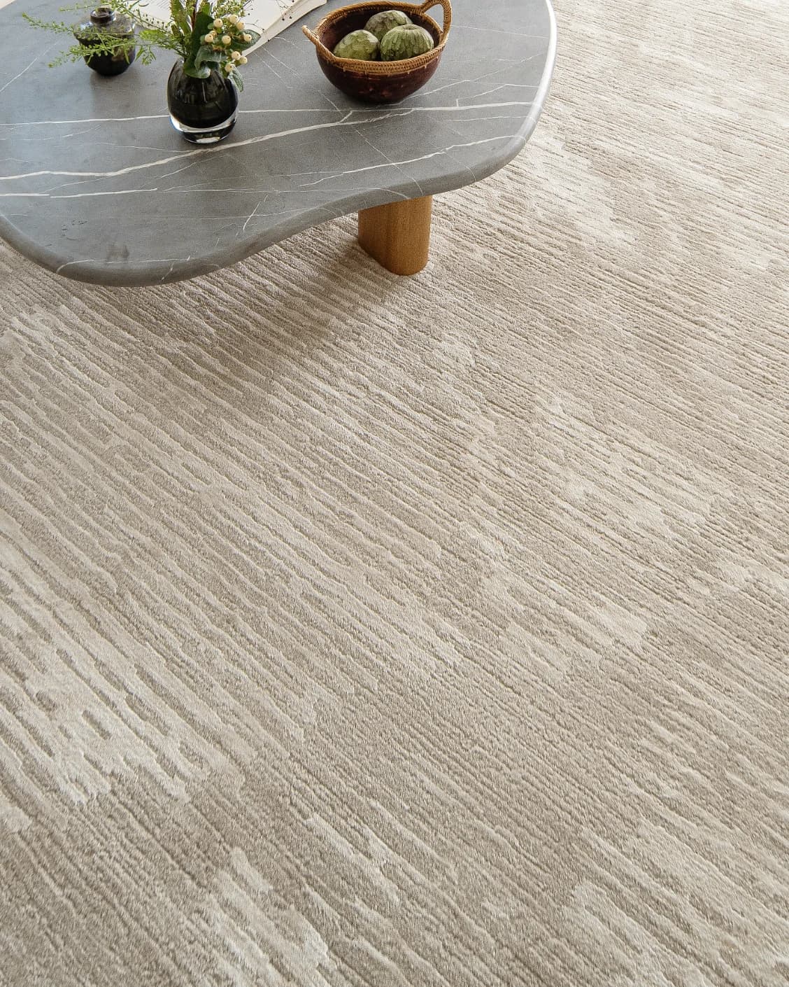Freida Sandy carpet in beige, shown in a lifestyle top view as image 9