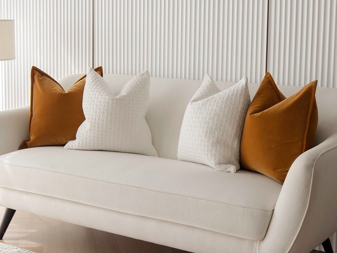 Gavin Bundle bundle cushions in orange, shown in a lifestyle front view