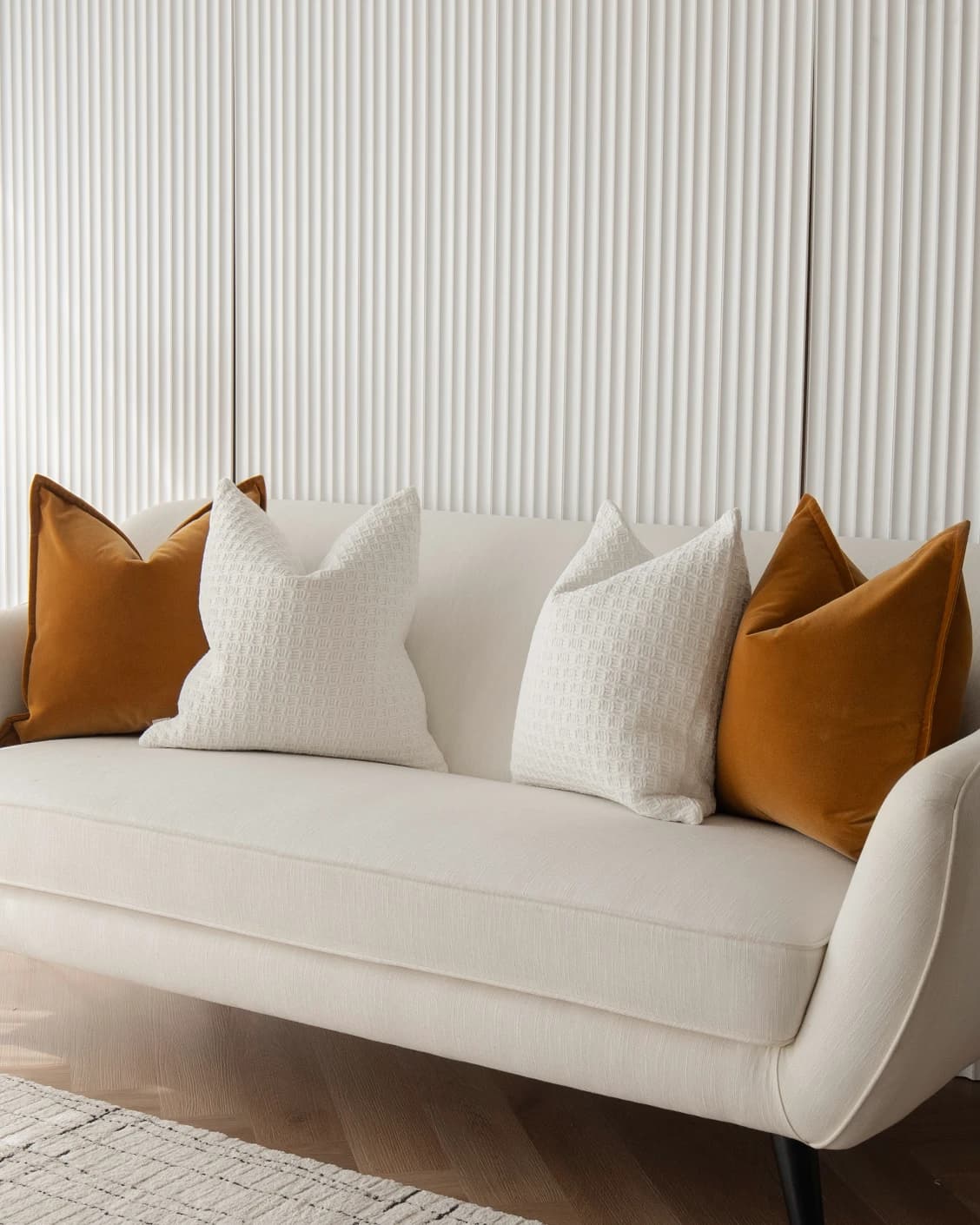 Gavin Bundle cushion in orange, shown in a lifestyle front view as image 2