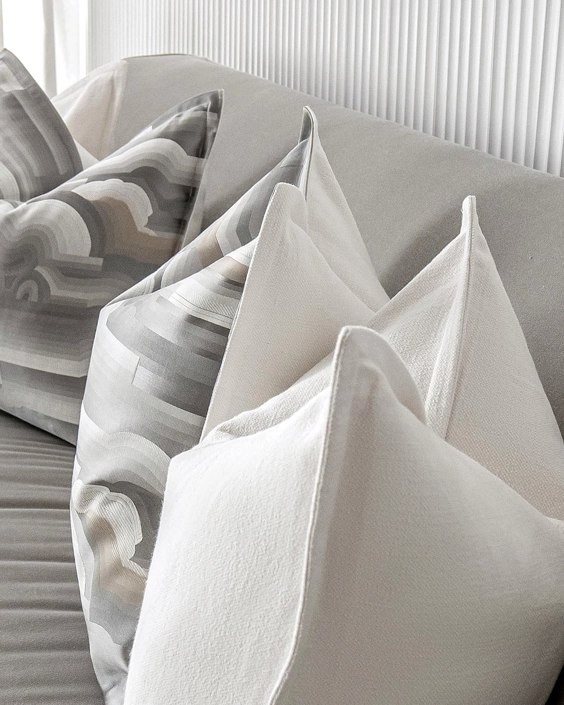 Georgina Bundle cushion in white and grey, shown in a lifestyle close-up as image 7