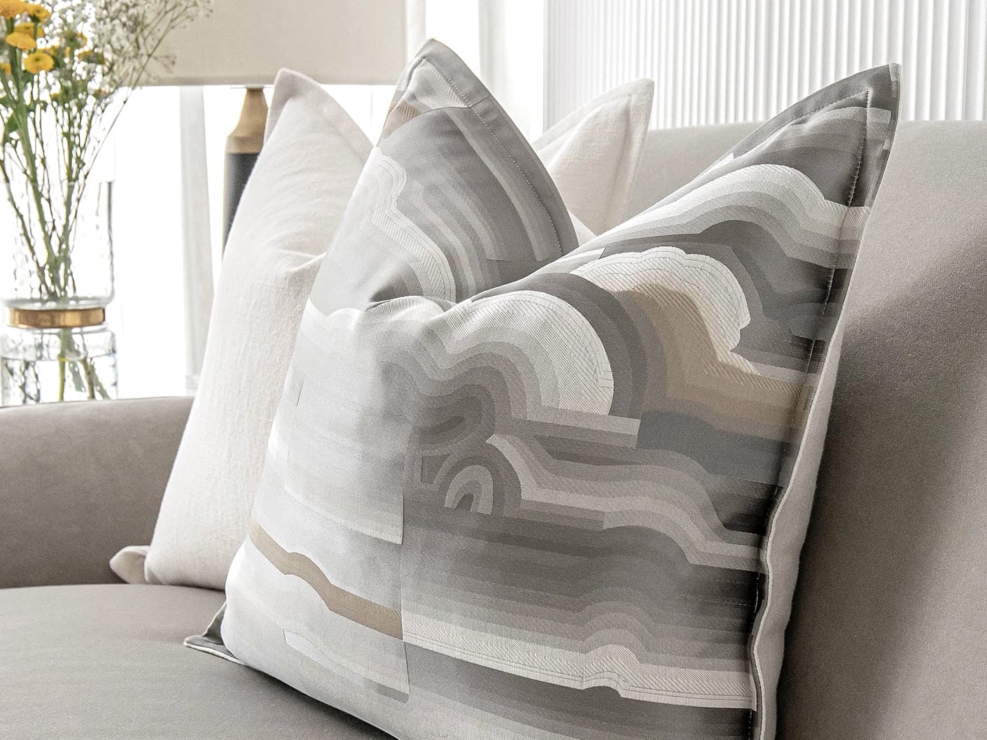 Georgina Bundle cushion in white and grey, shown in a lifestyle close-up as image 9