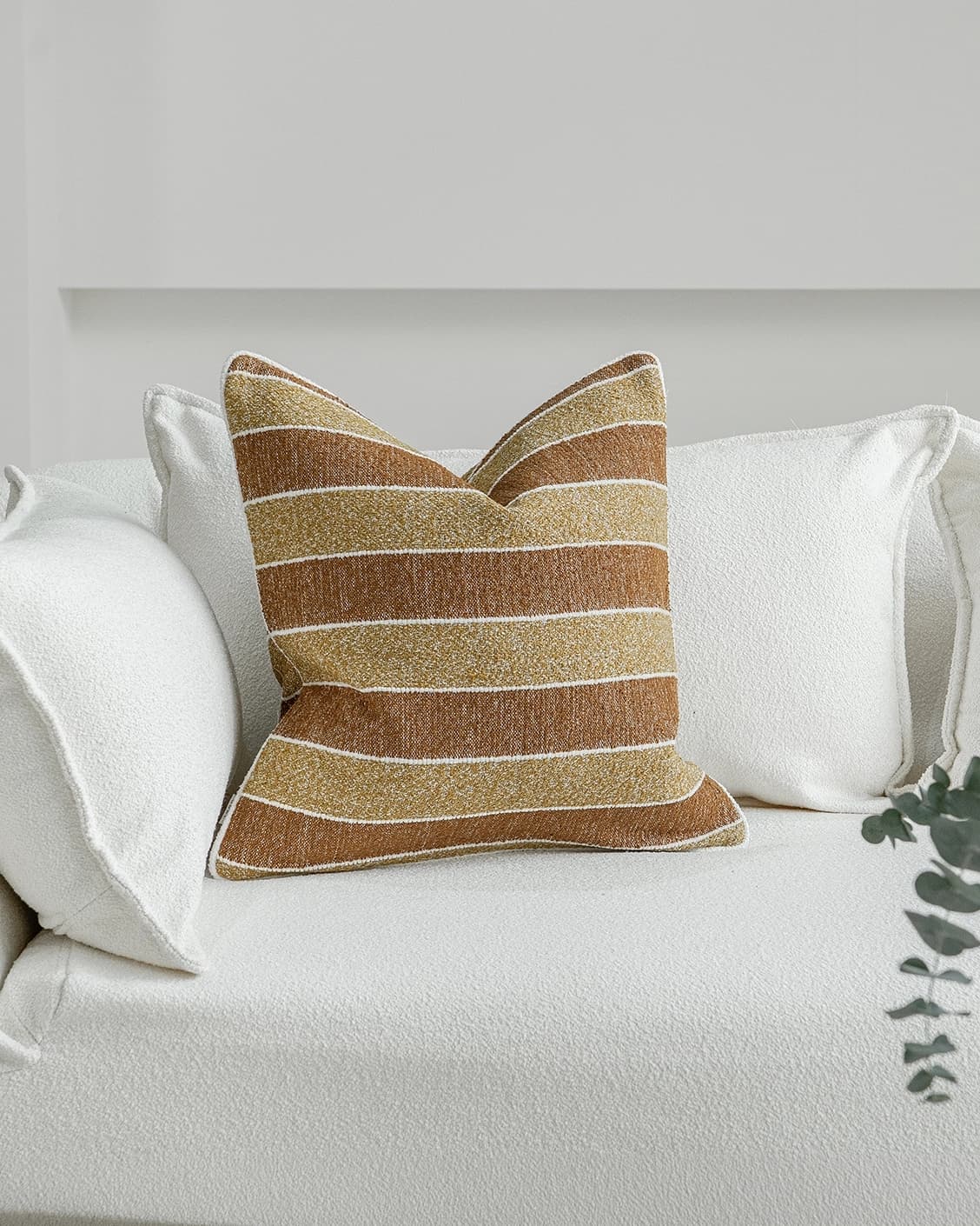 Gia Klimt cushion in brown and rust, shown in a lifestyle front view as image 2