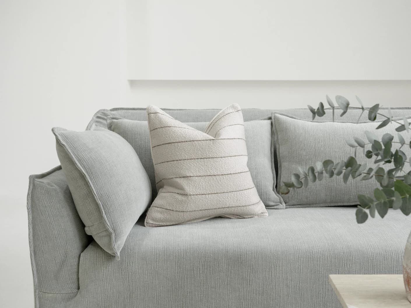 Gia Laurent single cushions in ivory, shown in a lifestyle front view