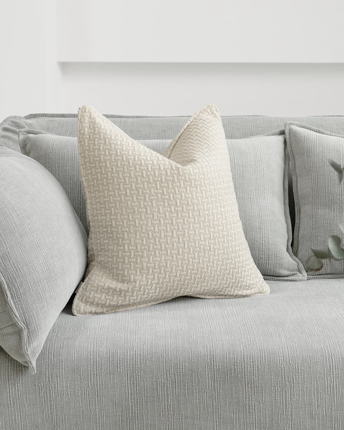 Gigi Laurent cushion in ivory, shown in a lifestyle front view as image 2