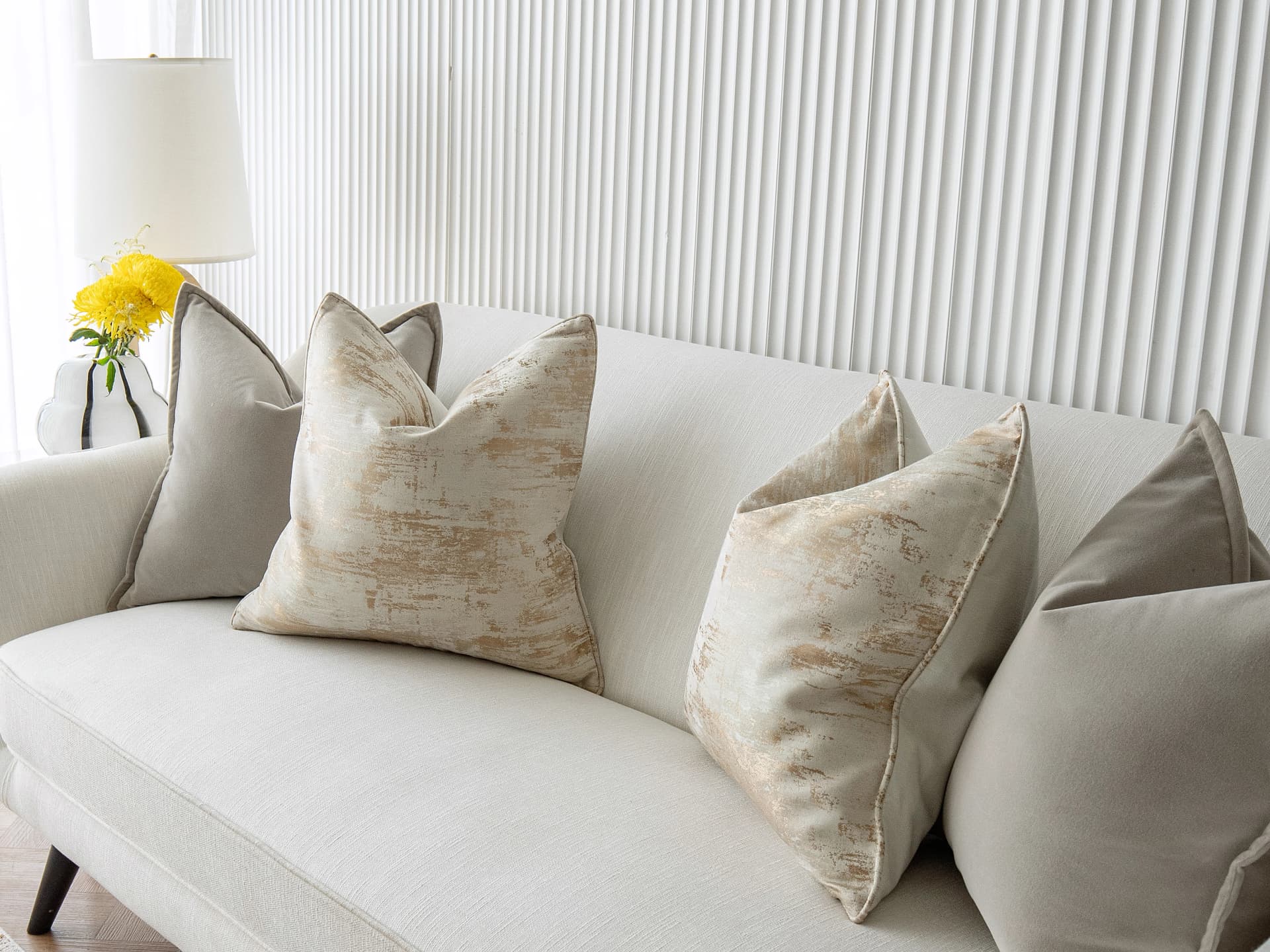 Goldea Bundle bundle cushions in grey, yellow and silver, shown in a lifestyle front view