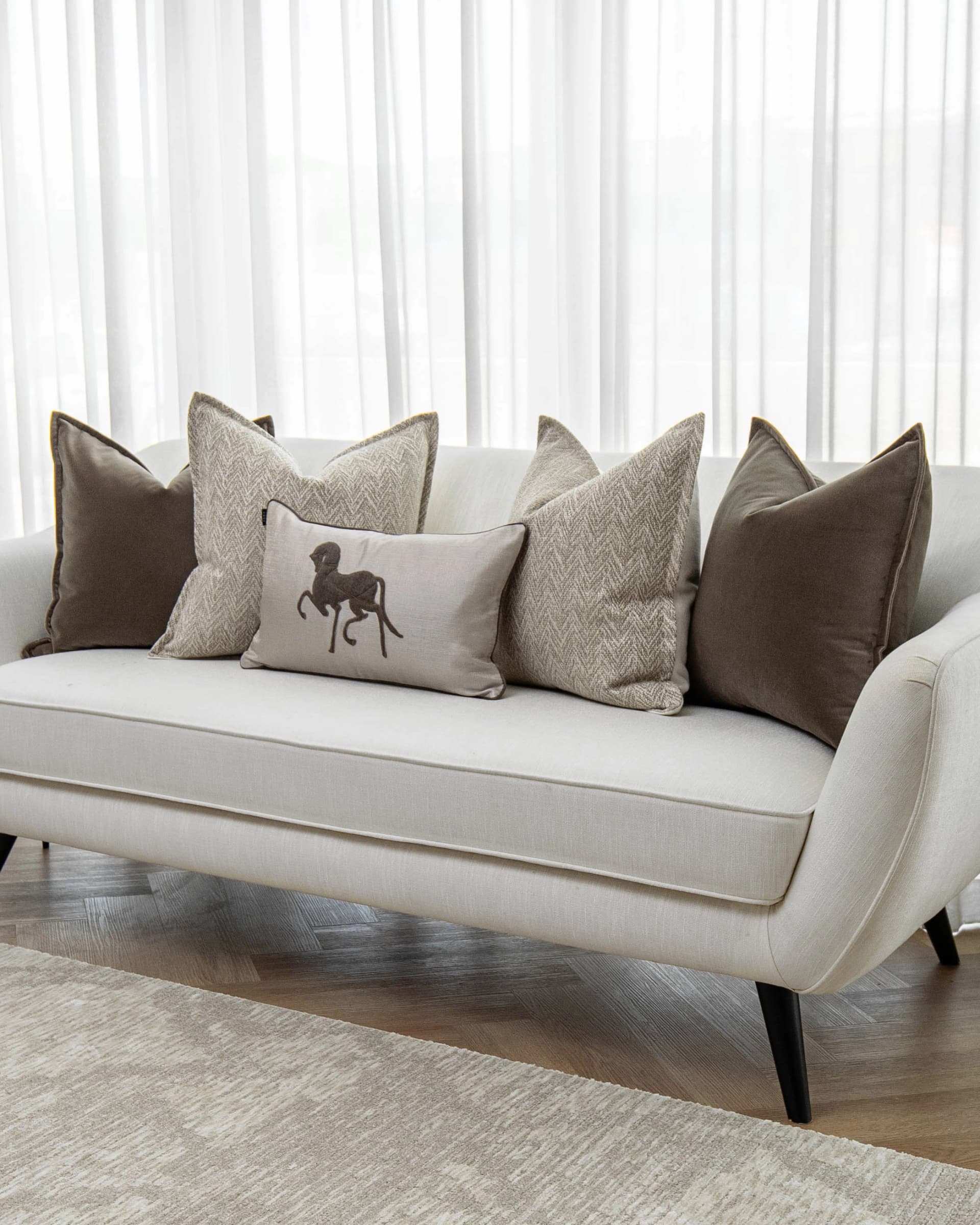 Gracia Bundle cushion in brown, shown in a lifestyle front view as image 2