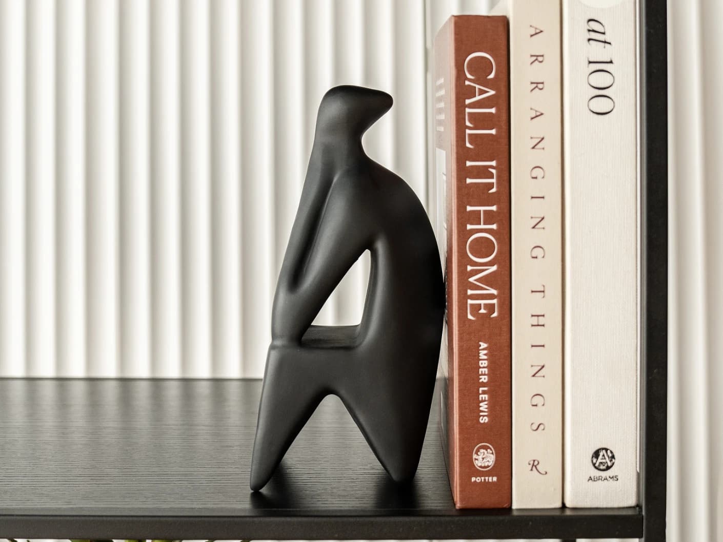 Hakim Arneson statues and sculptures in black, shown in a lifestyle front view