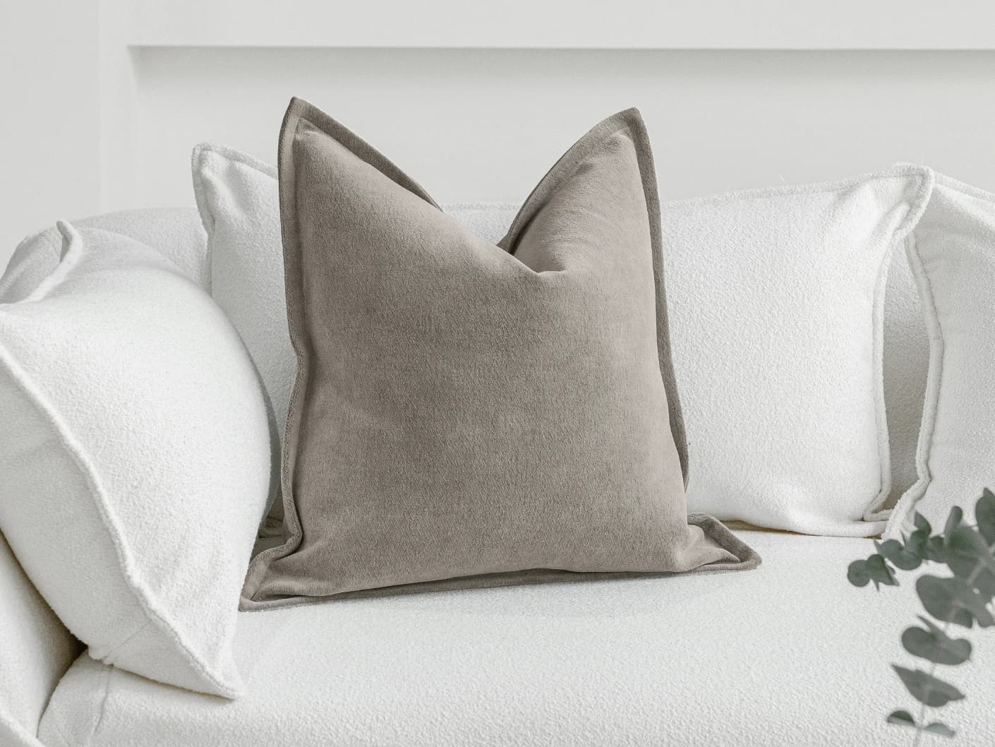 Haley Laurent single cushions in grey and taupe, shown in a lifestyle front view