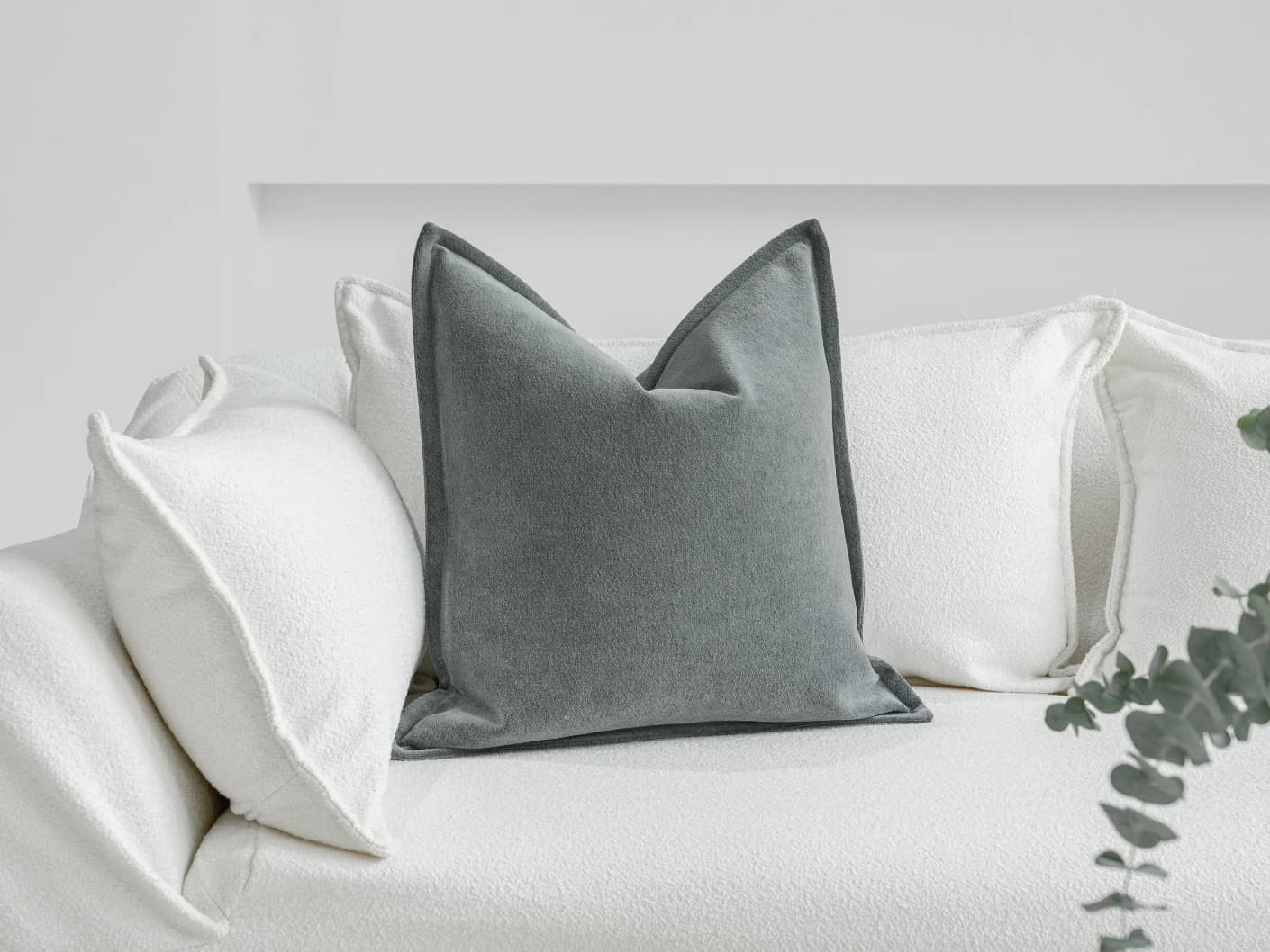 Haley Lucas single cushions in azure and grey, shown in a lifestyle front view