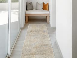 Hana Goldberg Runners carpet in gold, shown in a lifestyle front view