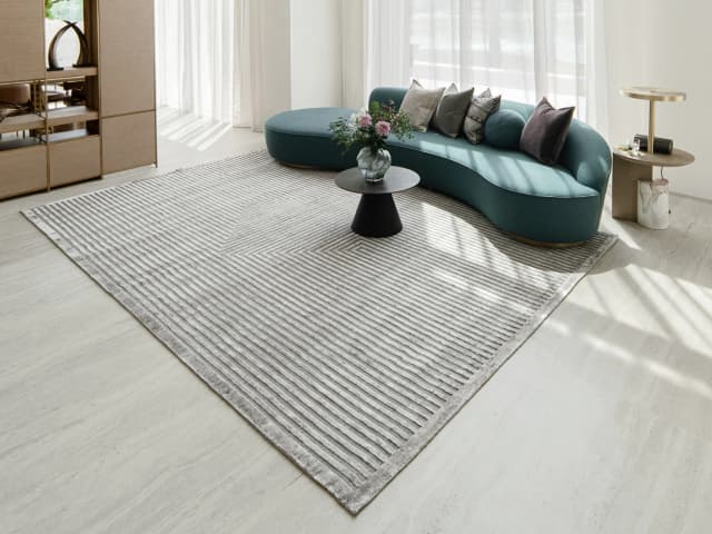 Harf Noon Ashton Round carpet in grey, shown in a lifestyle front view