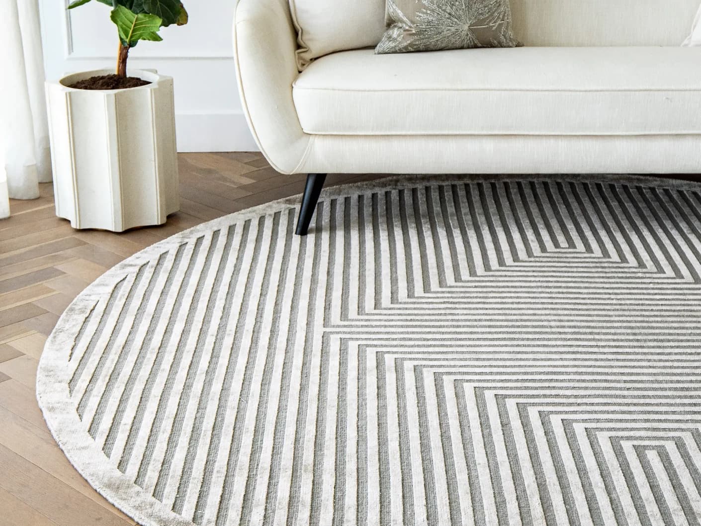 Harf Noon Ashton Round carpet in grey, shown in a lifestyle front view