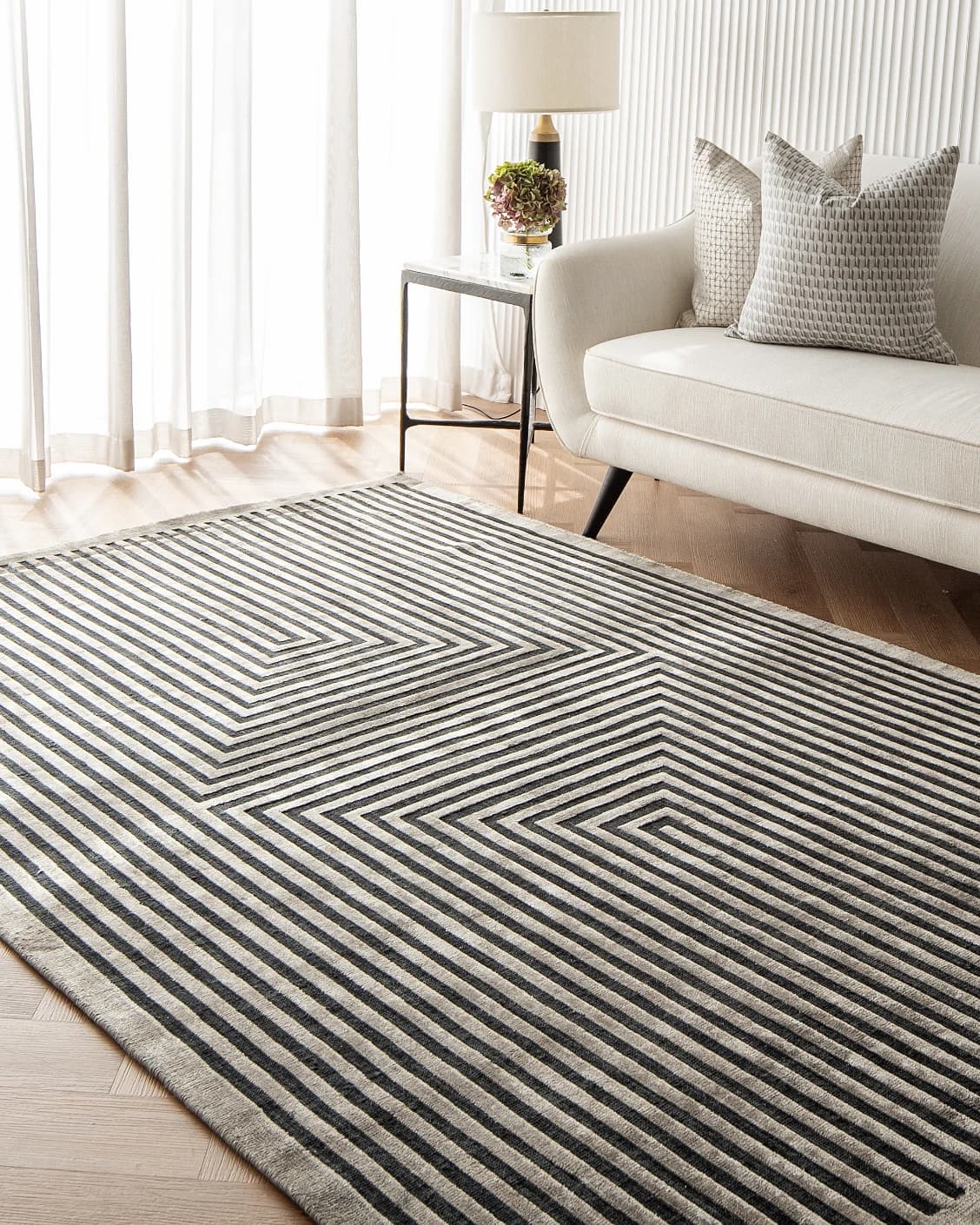 Harf Noon Ebony carpet in charcoal, shown in a lifestyle right view as image 5