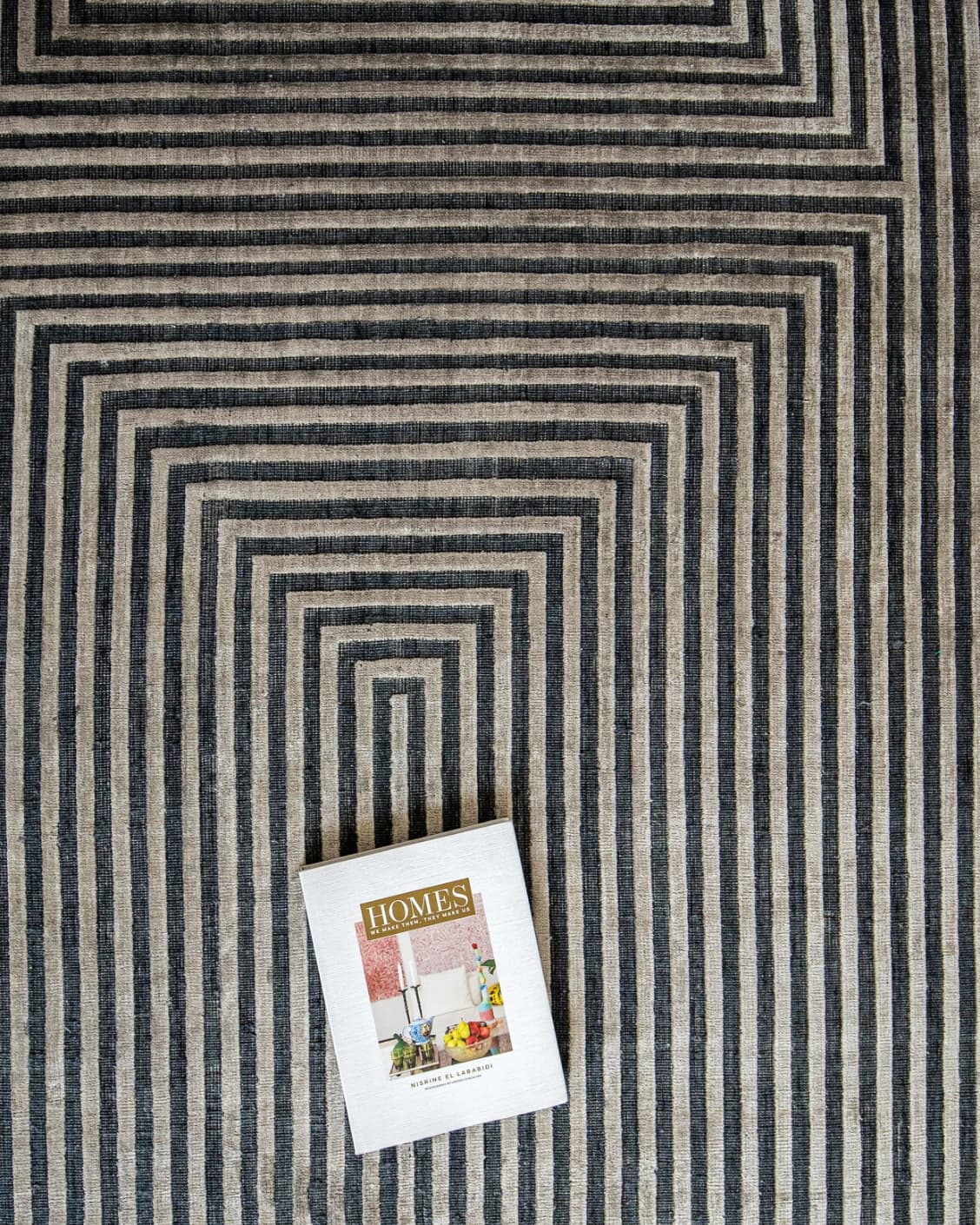 Harf Noon Ebony carpet in charcoal, shown in a lifestyle top view as image 6