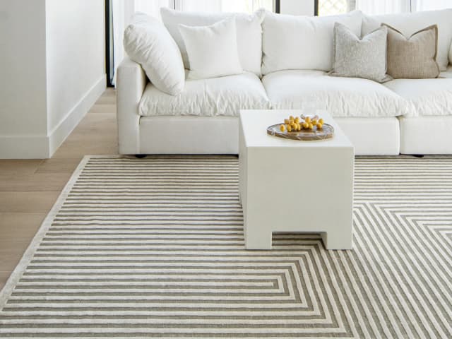 Harf Noon Sandy Round carpet in beige and ivory, shown in a lifestyle front view