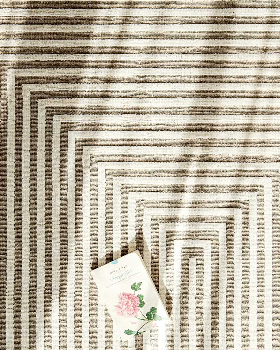 Harf Noon Sandy carpet in beige and ivory, shown in a lifestyle top view as image 9
