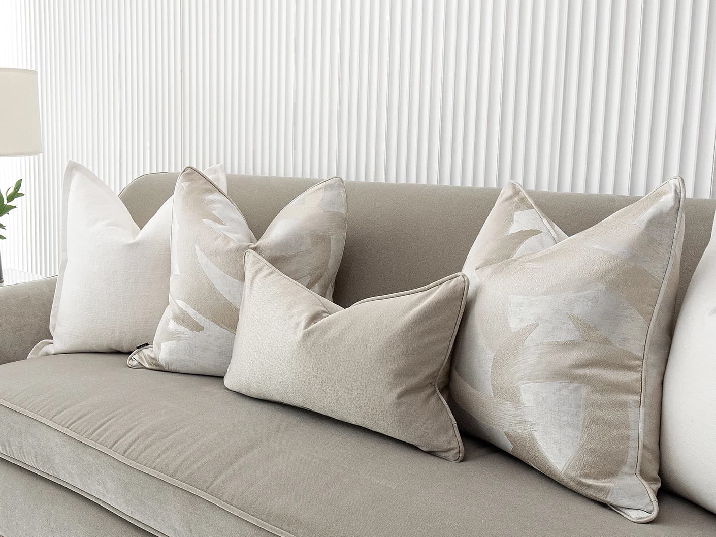 Harry Bundle bundle cushions in gold, beige, silver and white, shown in a lifestyle front view