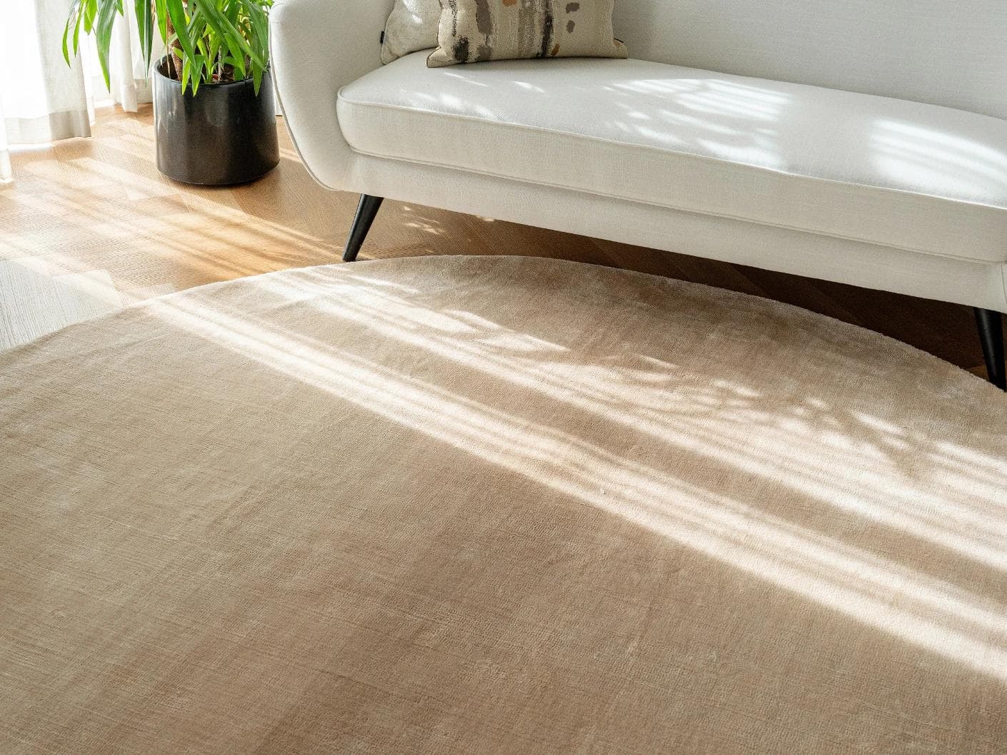 Hartman Sandy Round carpet in beige, shown in a lifestyle top view as image 4
