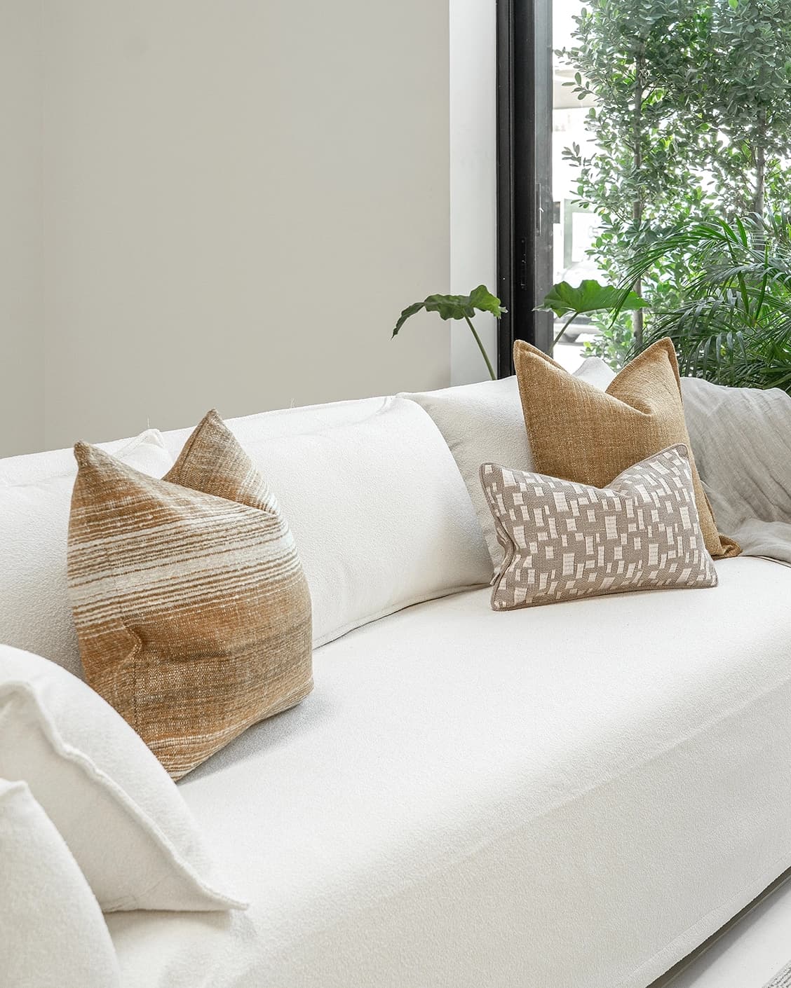 Hash Bundle bundle cushions in beige and yellow, shown in a lifestyle front view