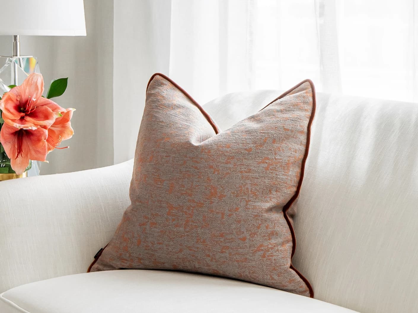 Hazel Tangelo single cushions in tangelo, orange and red, shown in a lifestyle front view